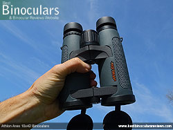 Hand holding the Athlon Ares 10x42 Binoculars