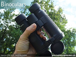 Hand holding the Opticron DBA VHD 10x42 Binoculars