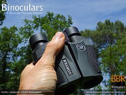 Holding the Compact Vortex Vanquish 10x26 Binoculars